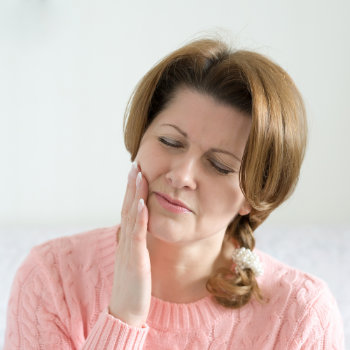 mature woman suffers from toothache