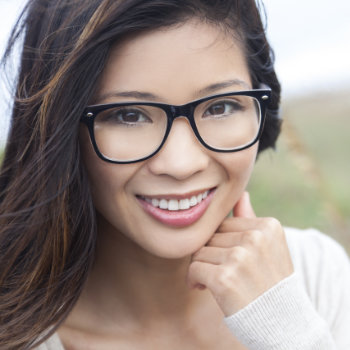 smiling asian woman wearing glasses with perfect smile